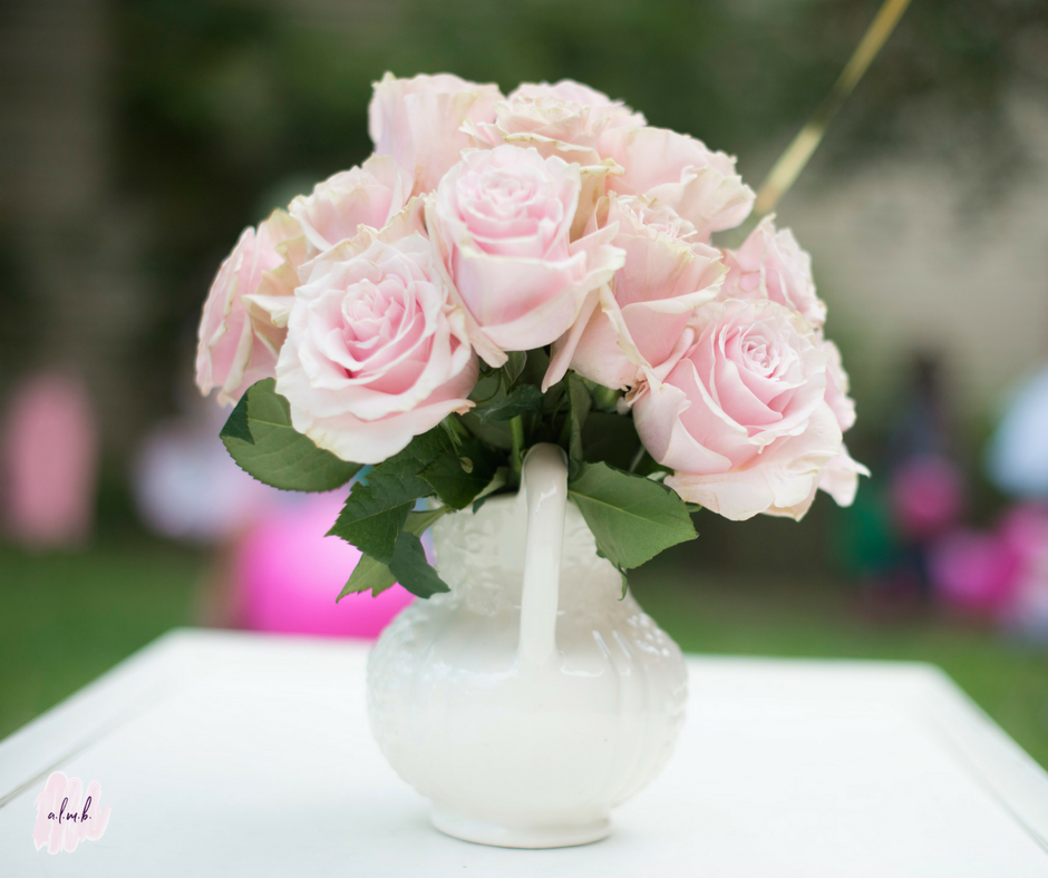 Simple pink roses adorned the tables on the lawn. || A Life More Beautiful