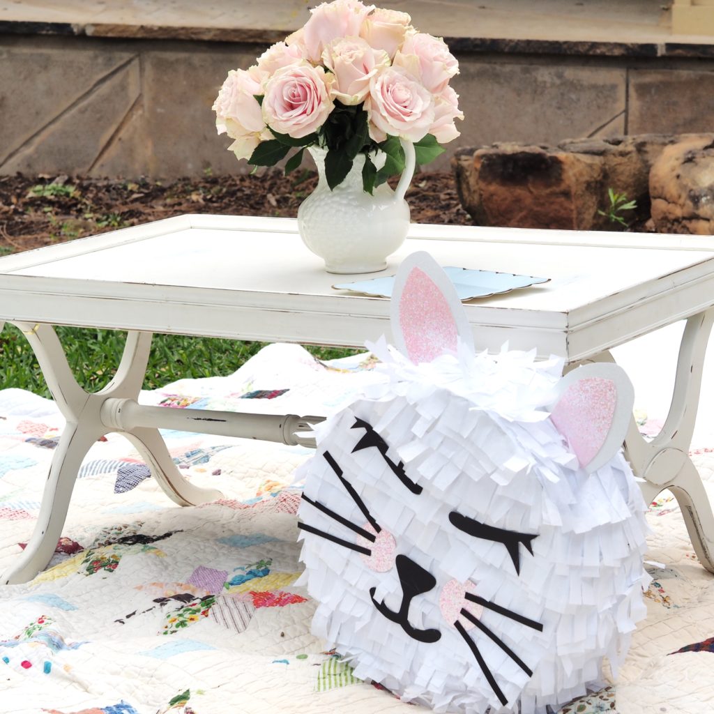 A homemade pinata & delicate florals accentuate the design of a pretty kitty birthday event by A Life More Beautiful
