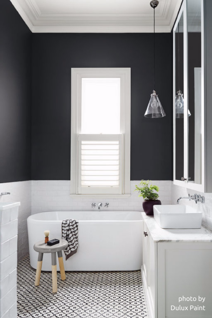 The dark walls add sophistication to this bathroom by Dulux Paint.
